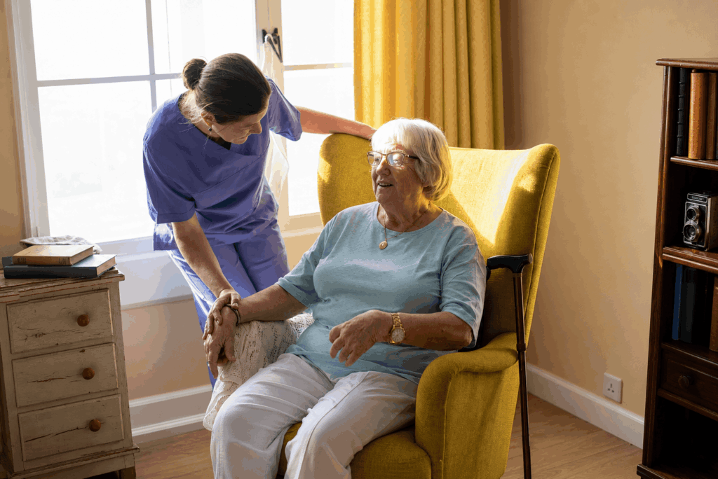 Caregiver tending to patient in chair